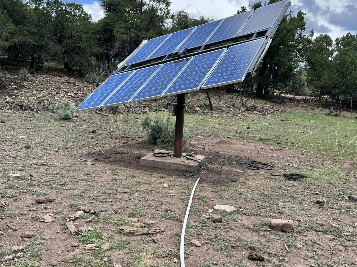 Solar array on a pole mount powering a water well in juniper ranch country