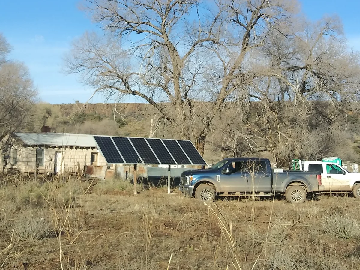 Low-mounted solar array running the well at a ranch headquarters